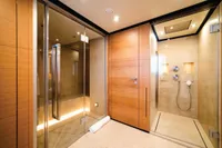 Luxurious modern bathroom with glass shower, wooden accents, and ambient lighting, ISA Custom 2012.