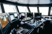 Modern ship control room with multiple screens and navigation equipment, ISA Custom 2012 model.