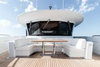 Luxurious ISA Custom 2012 yacht deck with white seating and wooden table.