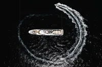 Aerial view of ISA Custom yacht with speedboat circling, 2012.