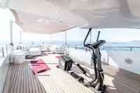 Luxurious yacht deck with gym equipment, lounge area, and ocean view, ISA Custom 2012 model.