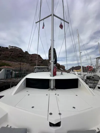 Seascape Yacht Photos Pics 2012 Leopard 39 catamaran docked, showcasing deck and mast under cloudy sky.