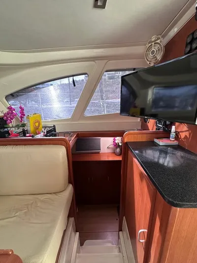 Seascape Yacht Photos Pics Interior of a 2012 Leopard 39 yacht with seating, TV, and decor.