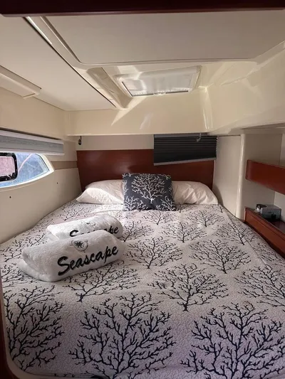 Seascape Yacht Photos Pics Cozy cabin interior of a 2012 Leopard 39 yacht with nautical-themed bedding.
