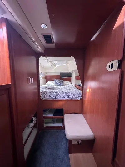 Seascape Yacht Photos Pics Interior of 2012 Leopard 39 yacht, featuring cozy cabin with bed and wooden furnishings.