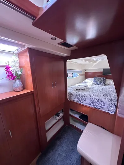 Seascape Yacht Photos Pics Interior of a 2012 Leopard 39 yacht cabin with wood finish and floral decor.
