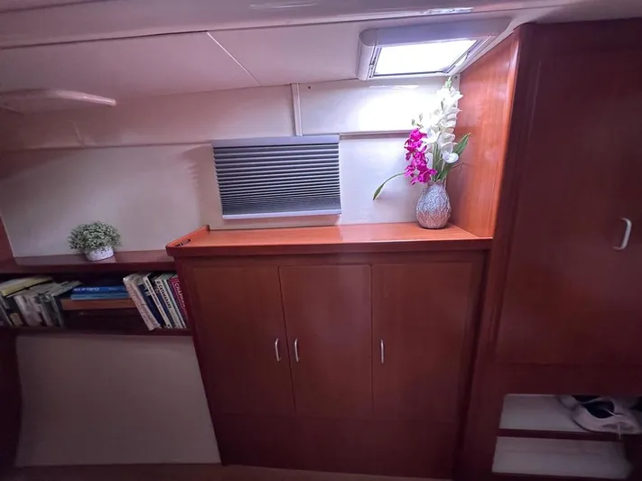 Seascape Yacht Photos Pics Interior of 2012 Leopard 39 yacht with wooden cabinets and decorative plants.