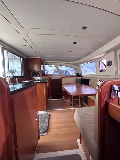 Seascape Yacht Photos Pics Interior of 2012 Leopard 39 catamaran with wood finishes and spacious seating area.