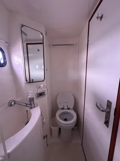 Seascape Yacht Photos Pics Compact bathroom in 2012 Leopard 39 yacht with toilet, sink, and mirror.
