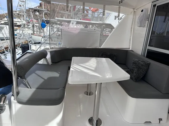 Seascape Yacht Photos Pics Interior of 2012 Leopard 39 yacht with gray seating and white table.