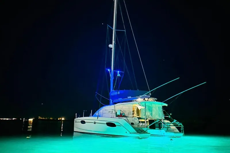Seascape Yacht Photos Pics Leopard 39 catamaran, 2012 model, illuminated at night on calm water.