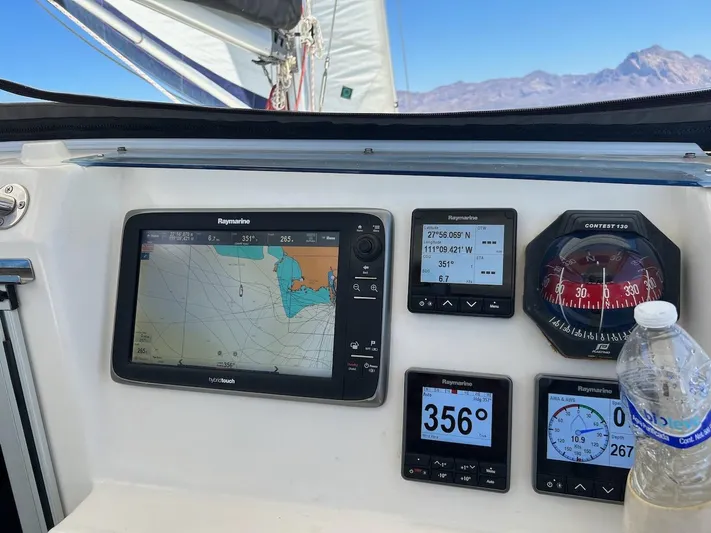 Seascape Yacht Photos Pics Sailing dashboard on 2012 Leopard 39 with navigation instruments and compass, ocean view in background.