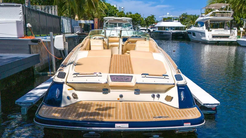 Levi Yacht Photos Pics 2013 Chris-Craft Launch 32 boat docked in a marina, featuring elegant design and spacious seating.