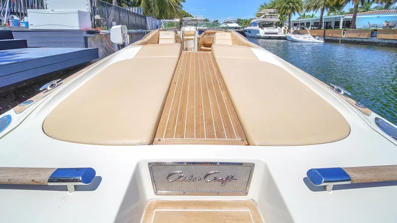 Levi Yacht Photos Pics 2013 Chris-Craft Launch 32 boat with teak deck, docked by the water.