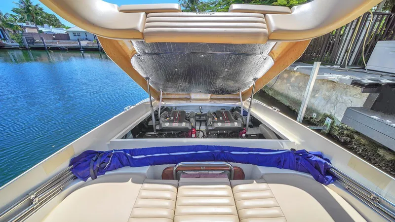 Levi Yacht Photos Pics 2013 Chris-Craft Launch 32 boat with open engine compartment by the water.