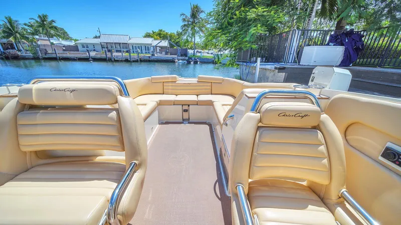 Levi Yacht Photos Pics 2013 Chris-Craft Launch 32 boat interior with tan leather seats, docked by a canal.