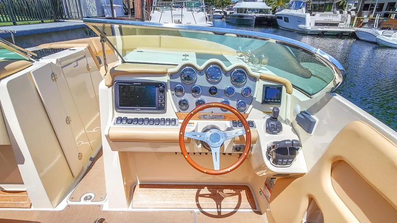 Levi Yacht Photos Pics 2013 Chris-Craft Launch 32 boat dashboard with wooden steering wheel and modern controls.