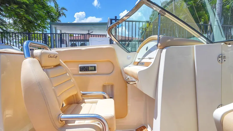 Levi Yacht Photos Pics 2013 Chris-Craft Launch 32 boat interior with beige seating and dashboard under sunny sky.