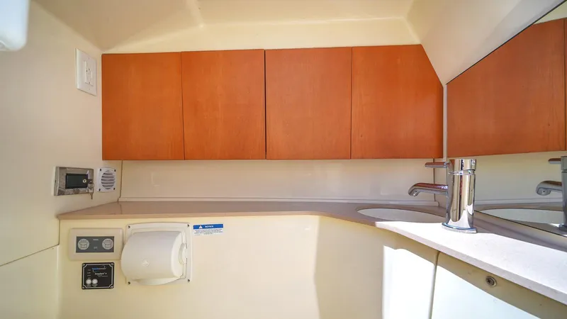 Levi Yacht Photos Pics 2013 Chris-Craft Launch 32 interior with wooden cabinets and modern sink.