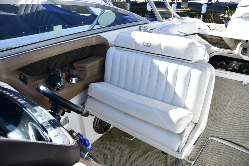  Yacht Photos Pics Interior of 2016 Cobalt 336 boat with white leather seating and steering controls.