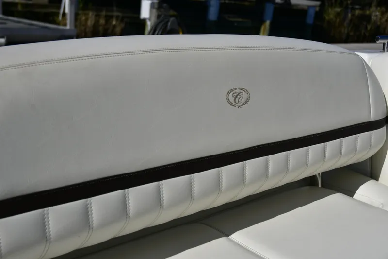  Yacht Photos Pics White leather seating in a 2016 Cobalt 336 boat, featuring elegant stitching and logo.