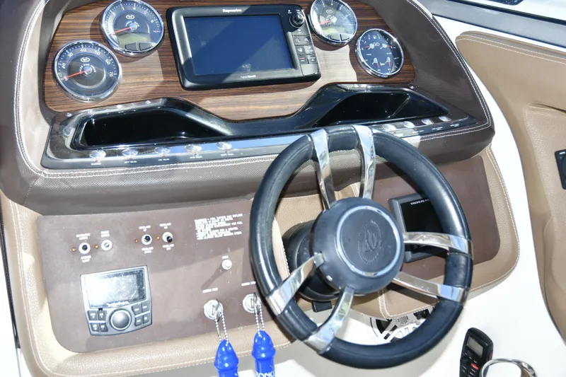  Yacht Photos Pics Dashboard of a 2016 Cobalt 336 boat with steering wheel and gauges.