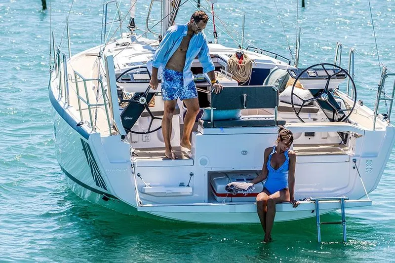  Yacht Photos Pics 2024 Dufour 37 sailboat with people enjoying a sunny day on the water.