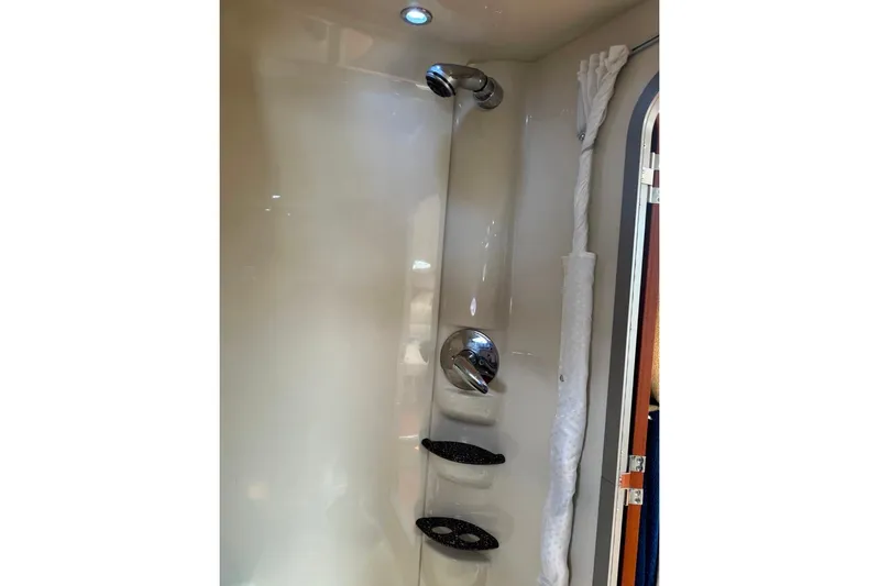 Silver Lining Yacht Photos Pics Shower area in 2008 Formula 400 Super Sport boat, featuring chrome fixtures and storage shelves.