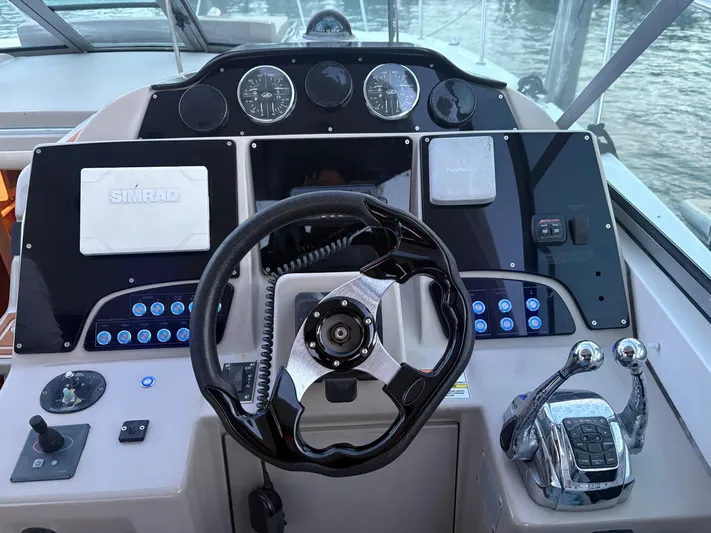  Yacht Photos Pics Cockpit of 2008 Sea Ray 330 Sundancer with steering wheel and control panel.
