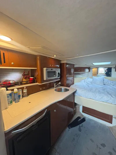  Yacht Photos Pics Interior of 2008 Sea Ray 330 Sundancer with kitchenette and cozy sleeping area.