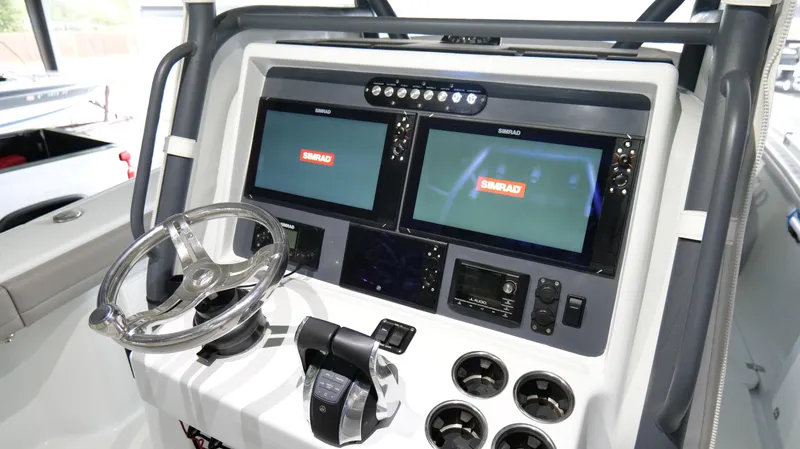 Engine Warranty X Trailer Yacht Photos Pics 2022 Yellowfin 34 boat dashboard with dual Simrad displays and steering wheel.