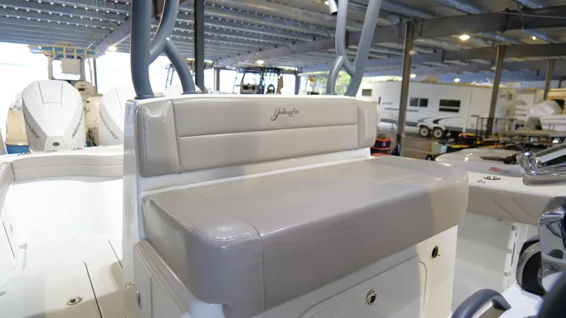 Engine Warranty X Trailer Yacht Photos Pics 2022 Yellowfin 34 boat interior with cushioned seating in a covered marina.