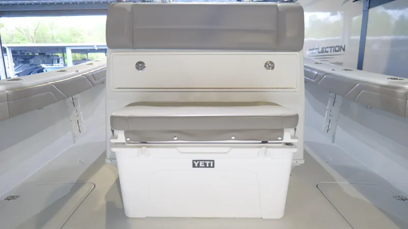 Engine Warranty X Trailer Yacht Photos Pics 2022 Yellowfin 34 boat interior with Yeti cooler and cushioned seating.
