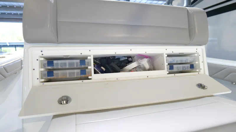 Engine Warranty X Trailer Yacht Photos Pics 2022 Yellowfin 34 boat storage compartment with organized tackle boxes and gear.