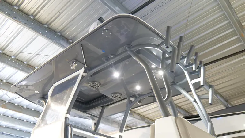 Engine Warranty X Trailer Yacht Photos Pics 2022 Yellowfin 34 boat with sleek T-top and rod holders in a metal-roofed storage.