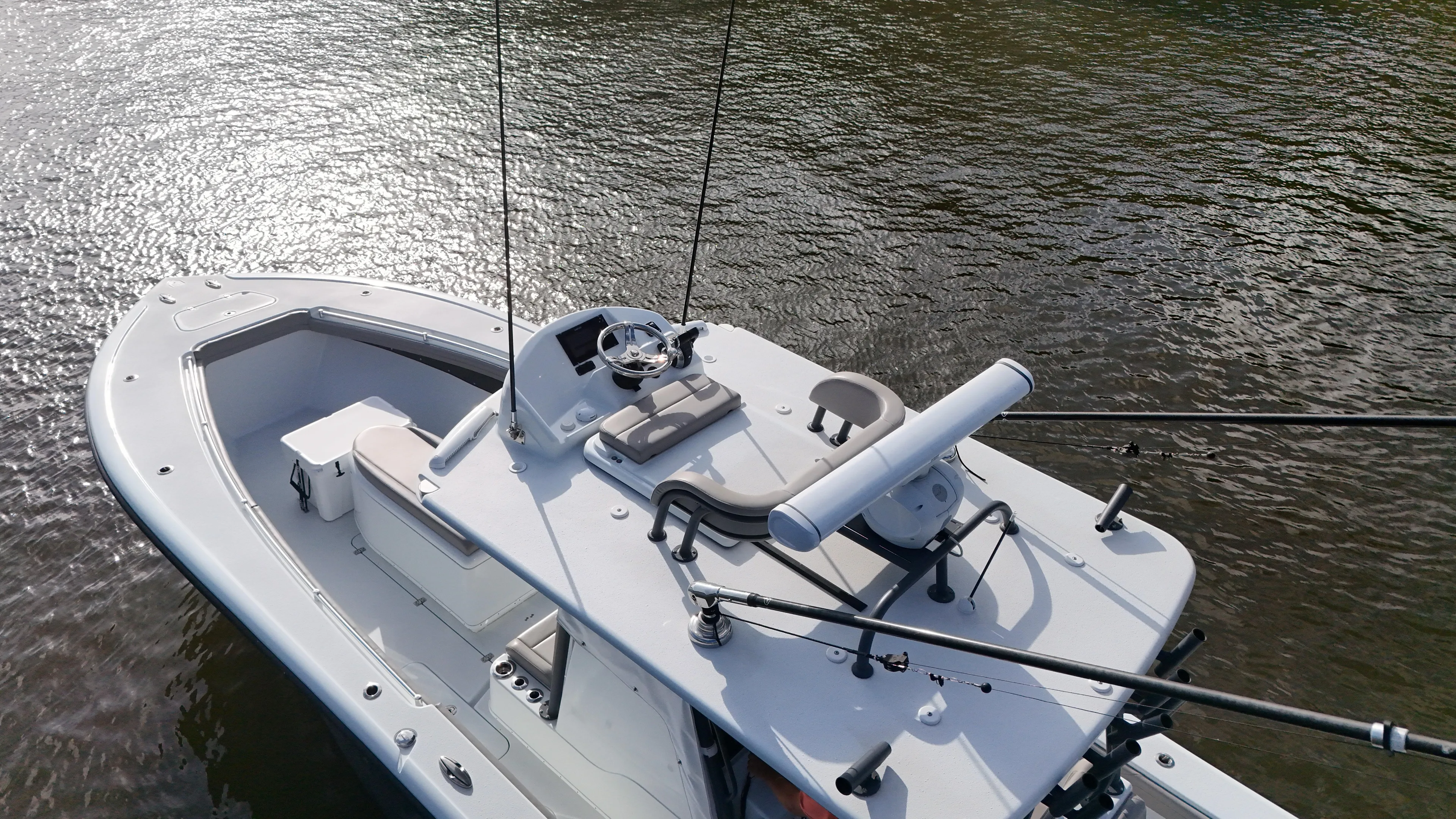 Engine Warranty X Trailer Yacht Photos Pics 2022 Yellowfin 34 boat on water, aerial view, sleek design, fishing rods visible.
