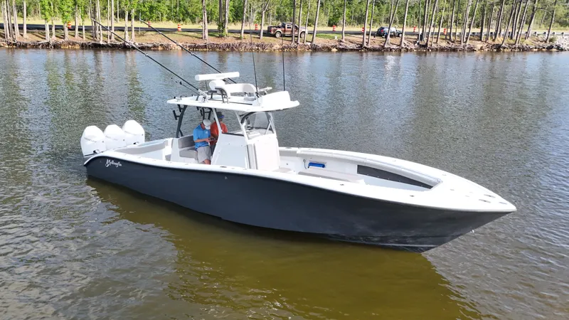 Engine Warranty X Trailer Yacht Photos Pics 2022 Yellowfin 34 boat on calm water, featuring triple outboard engines.