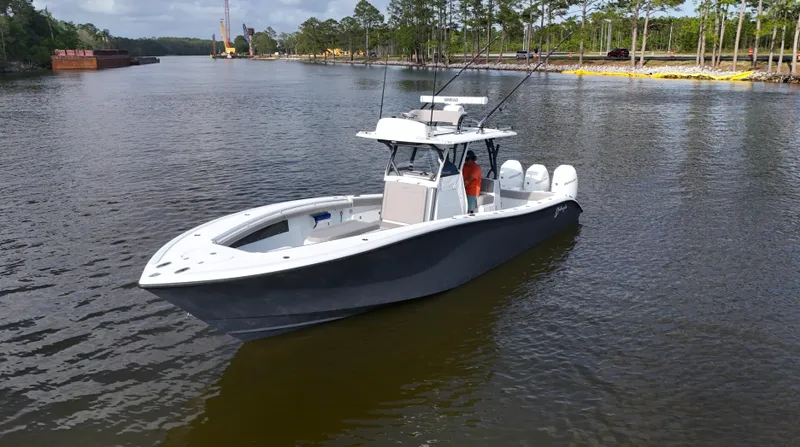 Engine Warranty X Trailer Yacht Photos Pics 2022 Yellowfin 34 boat on calm river with trees in background.