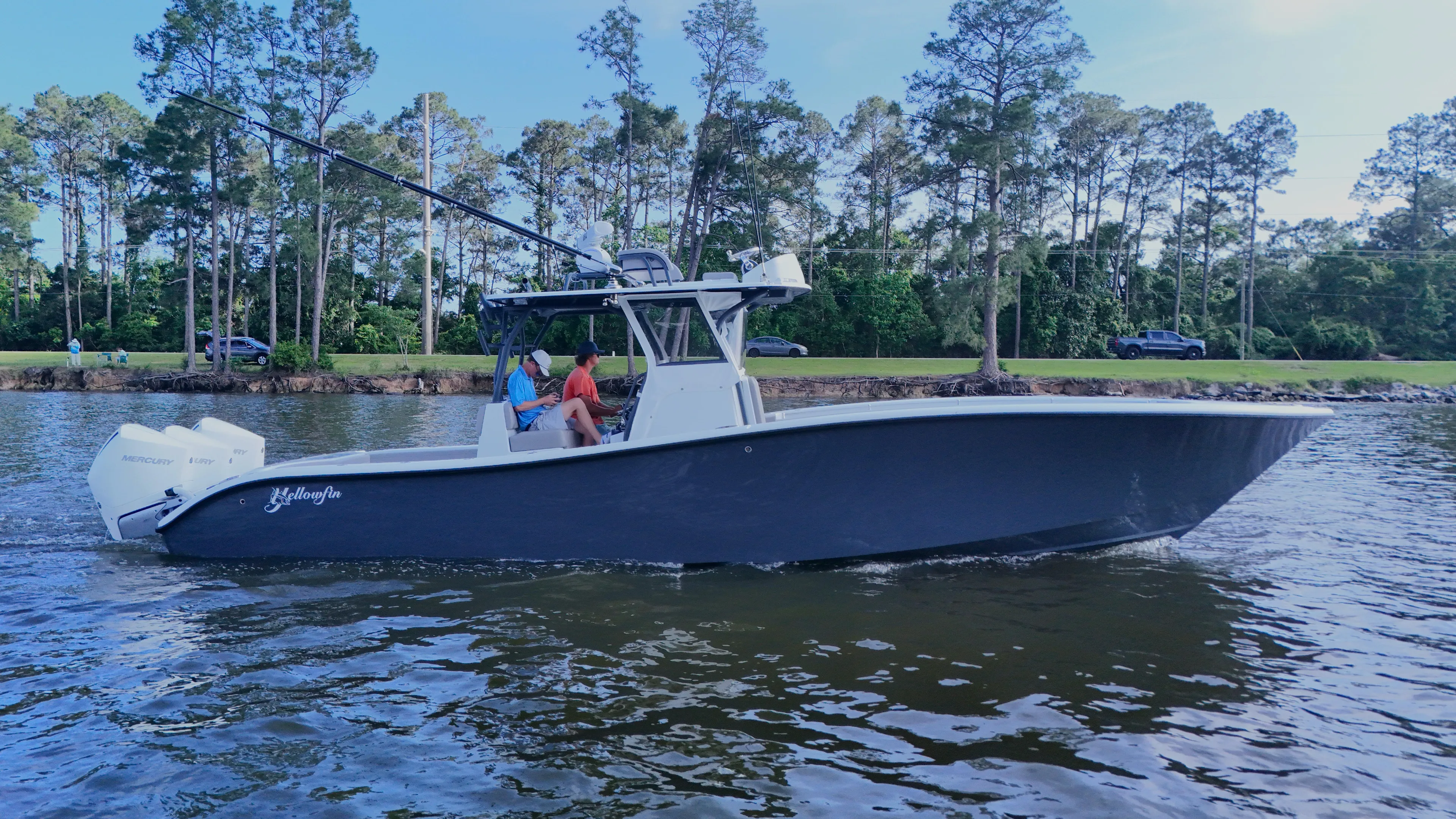 Engine Warranty X Trailer Yacht Photos Pics 2022 Yellowfin 34 boat cruising on a calm lake with trees in the background.