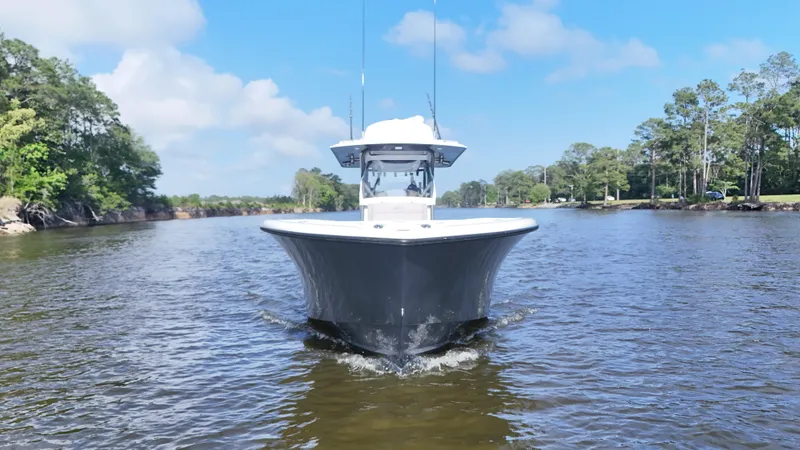 Engine Warranty X Trailer Yacht Photos Pics 2022 Yellowfin 34 boat cruising on a calm river under a clear blue sky.