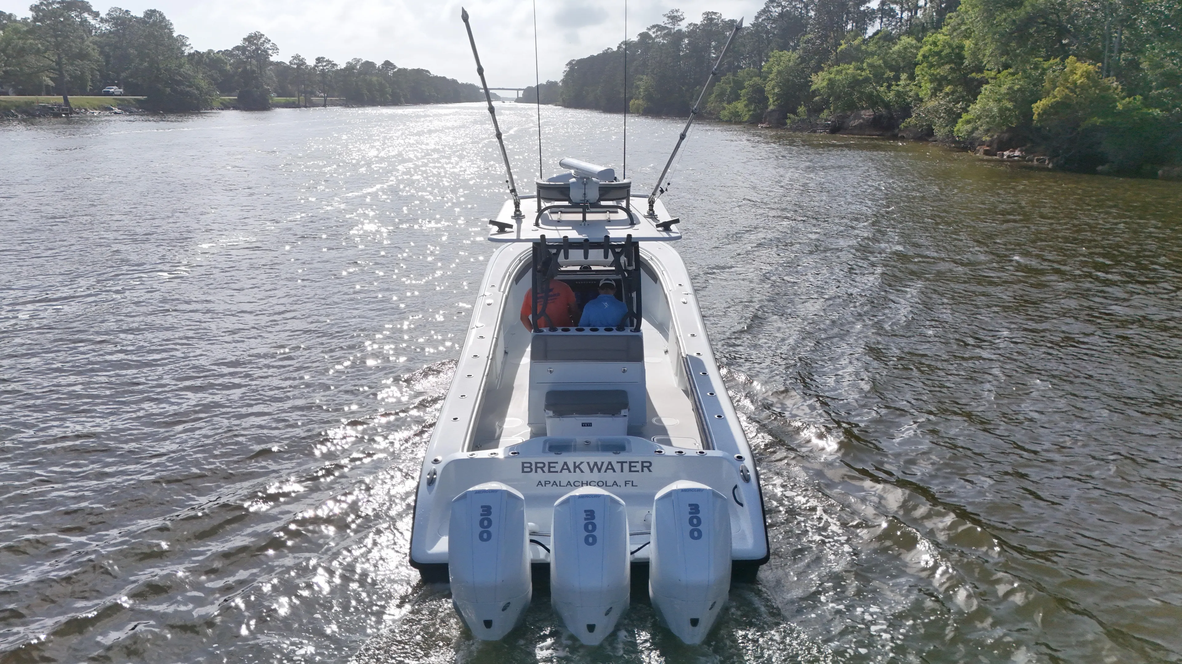 Engine Warranty X Trailer Yacht Photos Pics 2022 Yellowfin 34 boat cruising on a river with triple outboard engines.