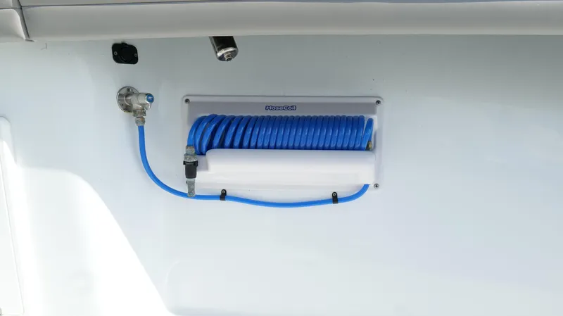 Engine Warranty X Trailer Yacht Photos Pics 2022 Yellowfin 34 boat with blue coiled hose and water connection.