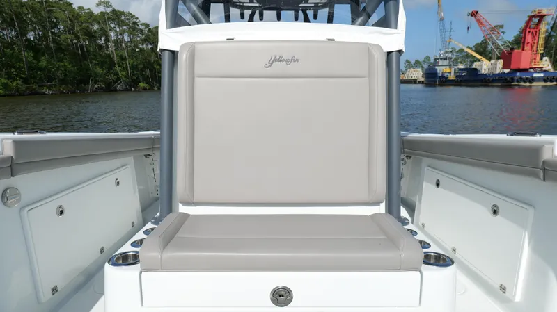 Engine Warranty X Trailer Yacht Photos Pics 2022 Yellowfin 34 boat seating area with gray cushions, docked by a river.