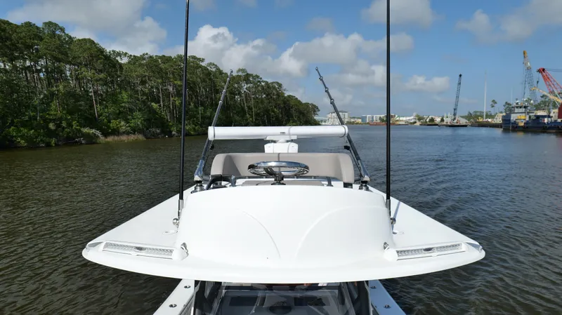 Engine Warranty X Trailer Yacht Photos Pics 2022 Yellowfin 34 boat on calm river with lush trees and blue sky.