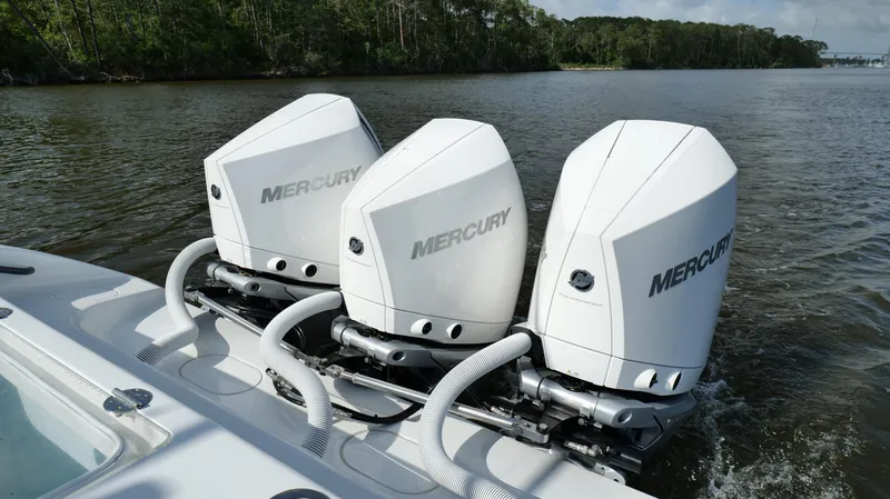 Engine Warranty X Trailer Yacht Photos Pics 2022 Yellowfin 34 boat with triple Mercury outboard engines on a calm river.