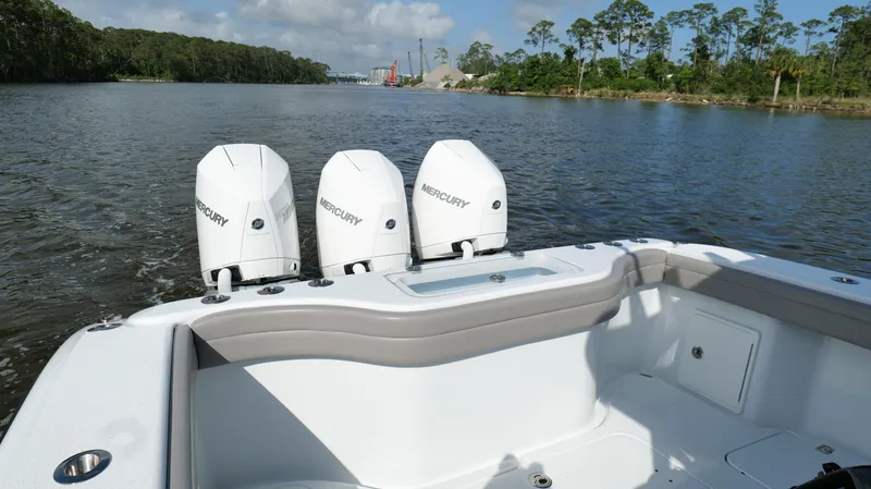Engine Warranty X Trailer Yacht Photos Pics 2022 Yellowfin 34 boat with triple Mercury engines on a calm river.