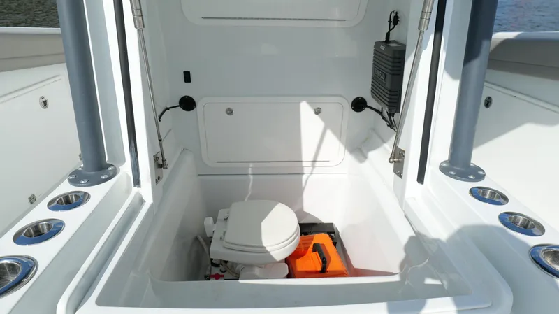 Engine Warranty X Trailer Yacht Photos Pics 2022 Yellowfin 34 boat interior with compact marine toilet and storage area.