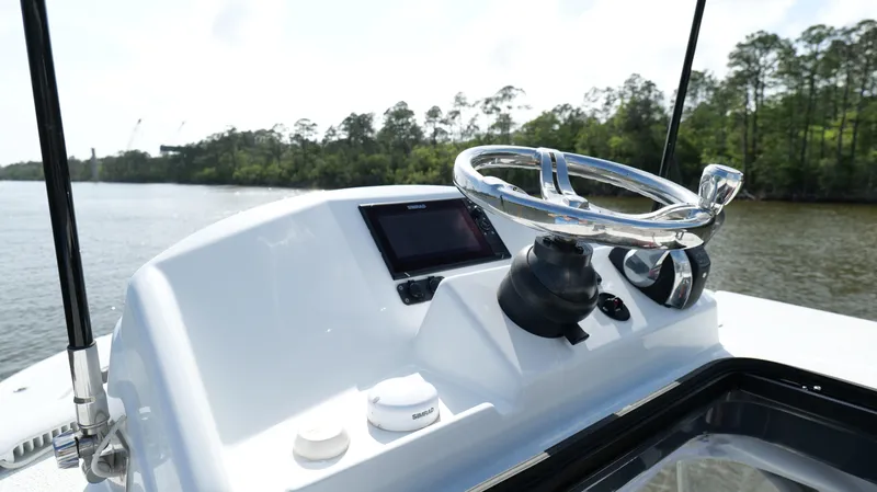 Engine Warranty X Trailer Yacht Photos Pics 2022 Yellowfin 34 boat helm with steering wheel and navigation display.