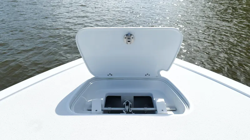 Engine Warranty X Trailer Yacht Photos Pics Open hatch on 2022 Yellowfin 34 boat, showing storage compartment by the water.