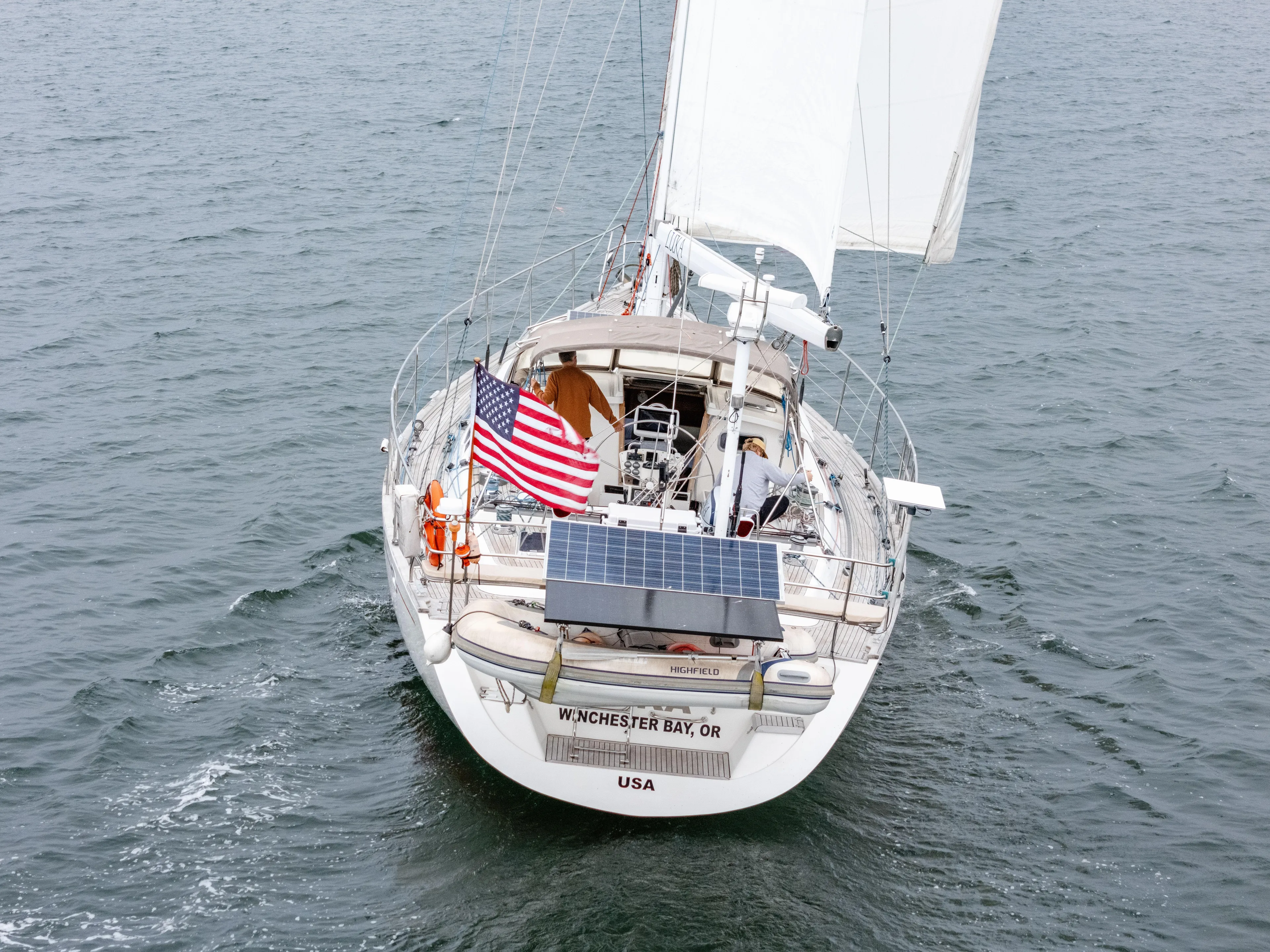 Luka Yacht Photos Pics Sailing yacht Farr 60 Pilot House 1997 with American flag on open water.